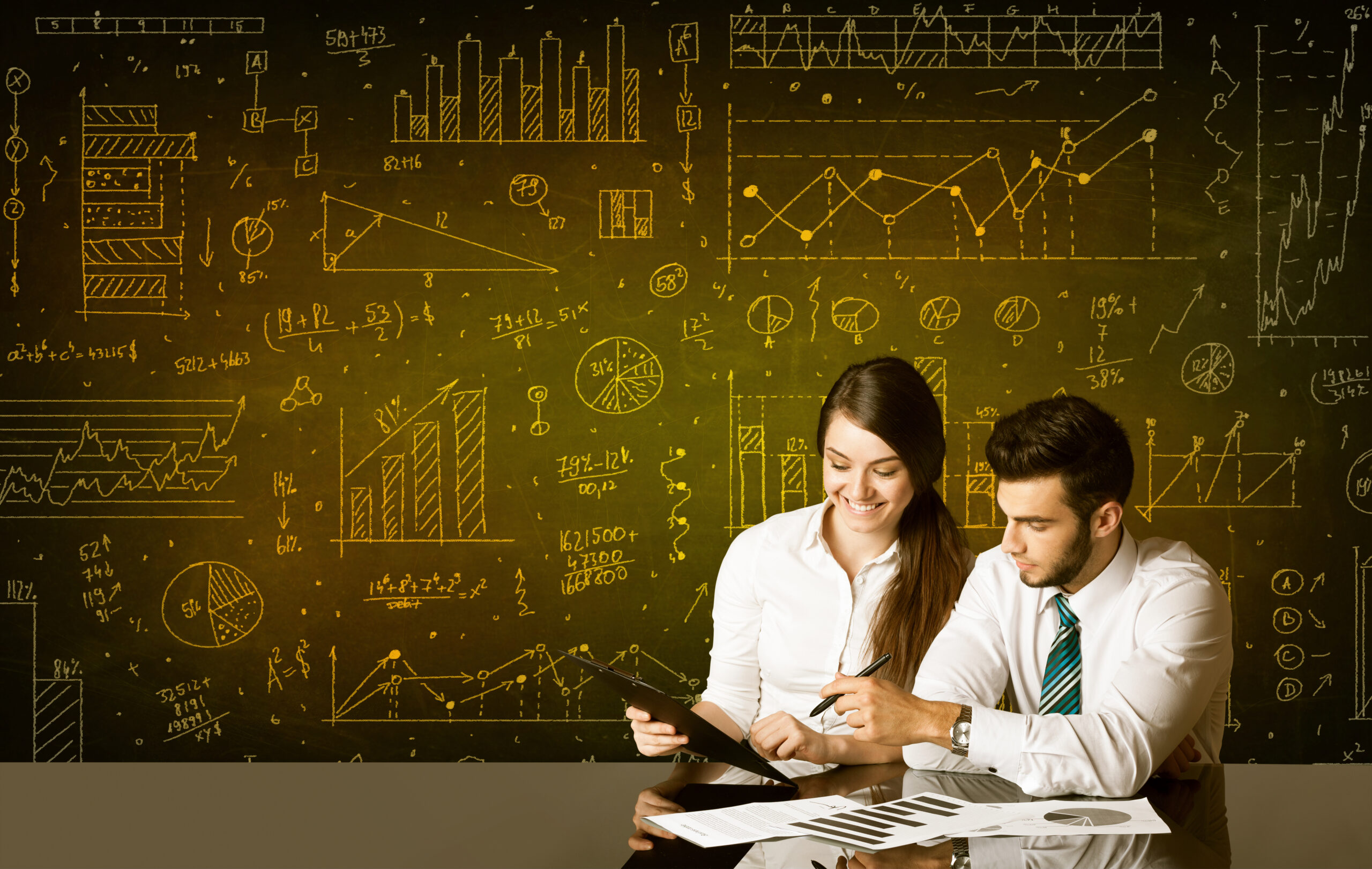 Business,Couple,Sitting,At,Black,Table,With,Hand,Drawn,Diagram